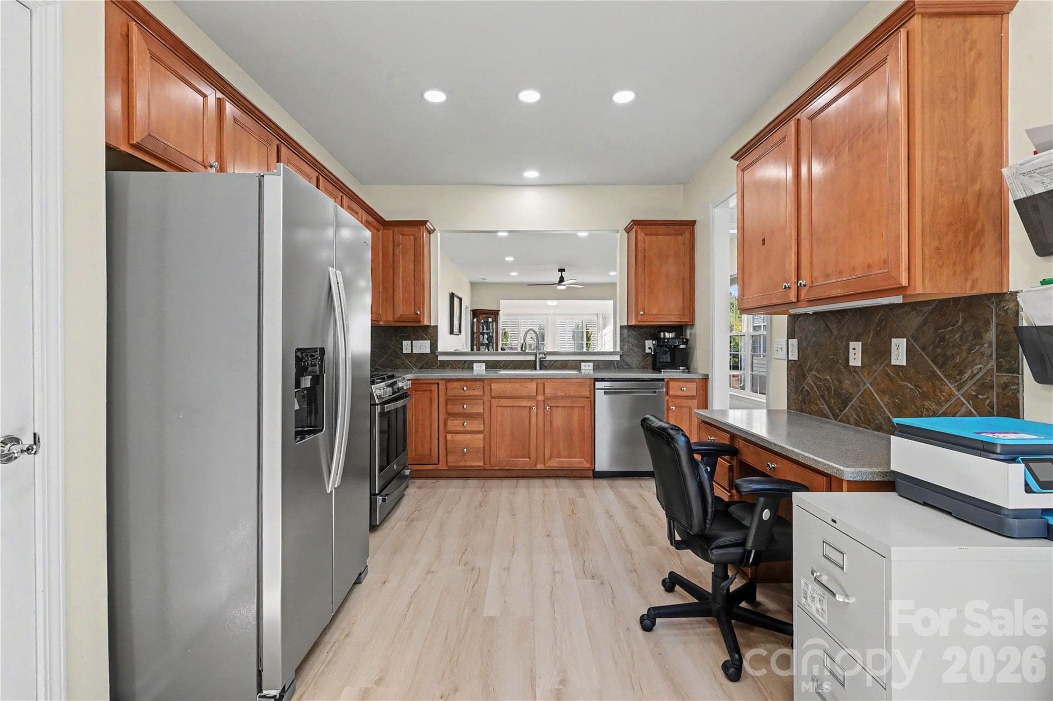 Kitchen view shows NEW LVP flooring, SS appliances, and ample cabinets and counterspace. - 3054 Azalea Drive, Indian Land