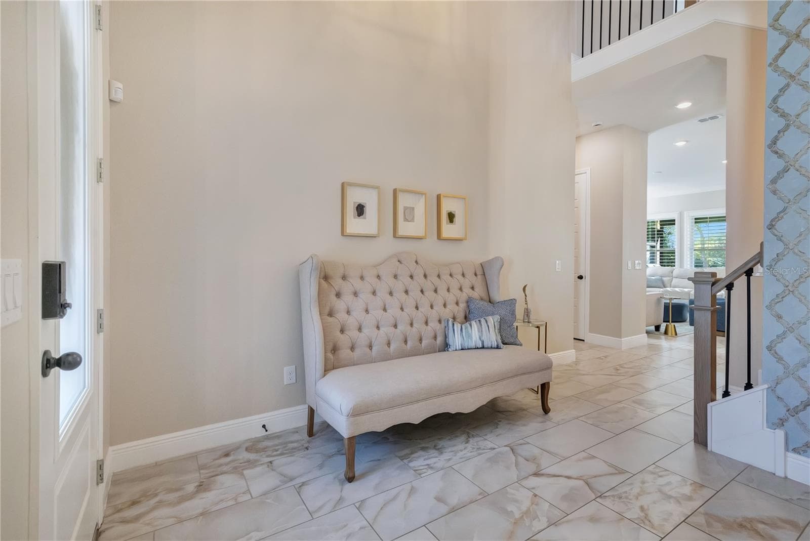 Bright foyer with soaring ceilings and upgraded tile flooring creates an inviting first impression. - 17600 LAKE STAR RD, WINTER GARDEN