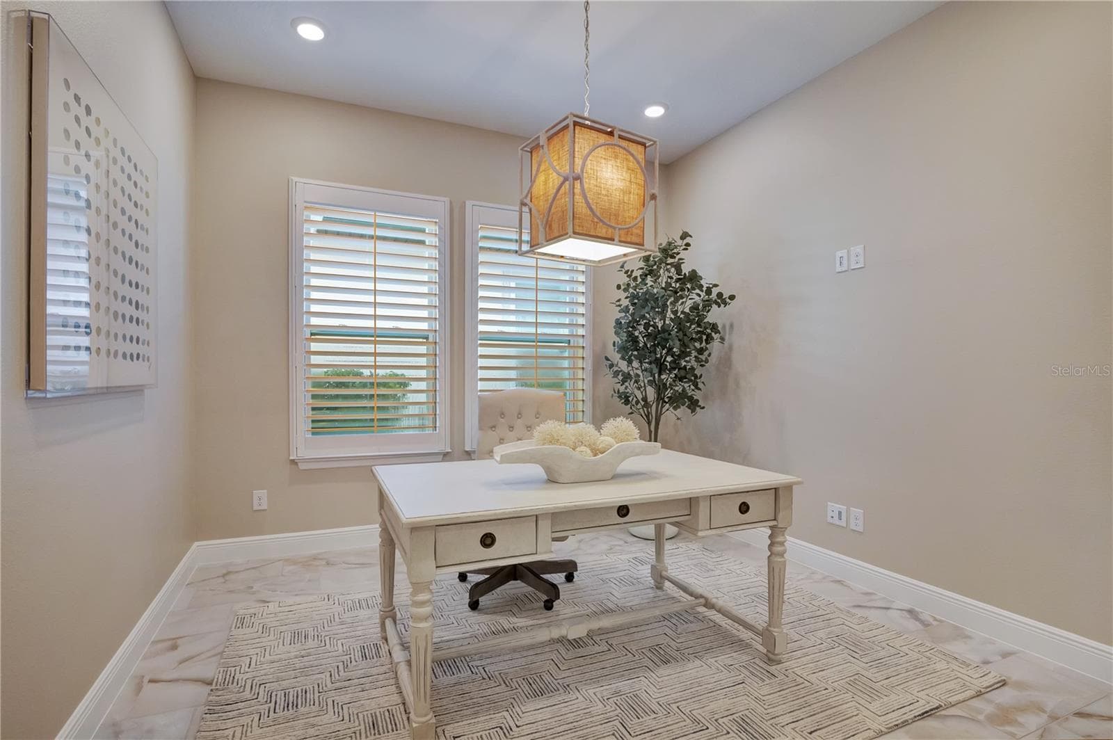 Dedicated office featuring plantation shutters, recessed lighting and a decorative pendant fixture. - 17600 LAKE STAR RD, WINTER GARDEN