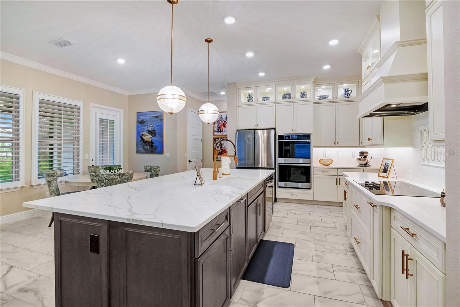 Beautifully appointed kitchen featuring a decorative backsplash, statement range hood and abundant cabinet storage. - 17600 LAKE STAR RD, WINTER GARDEN