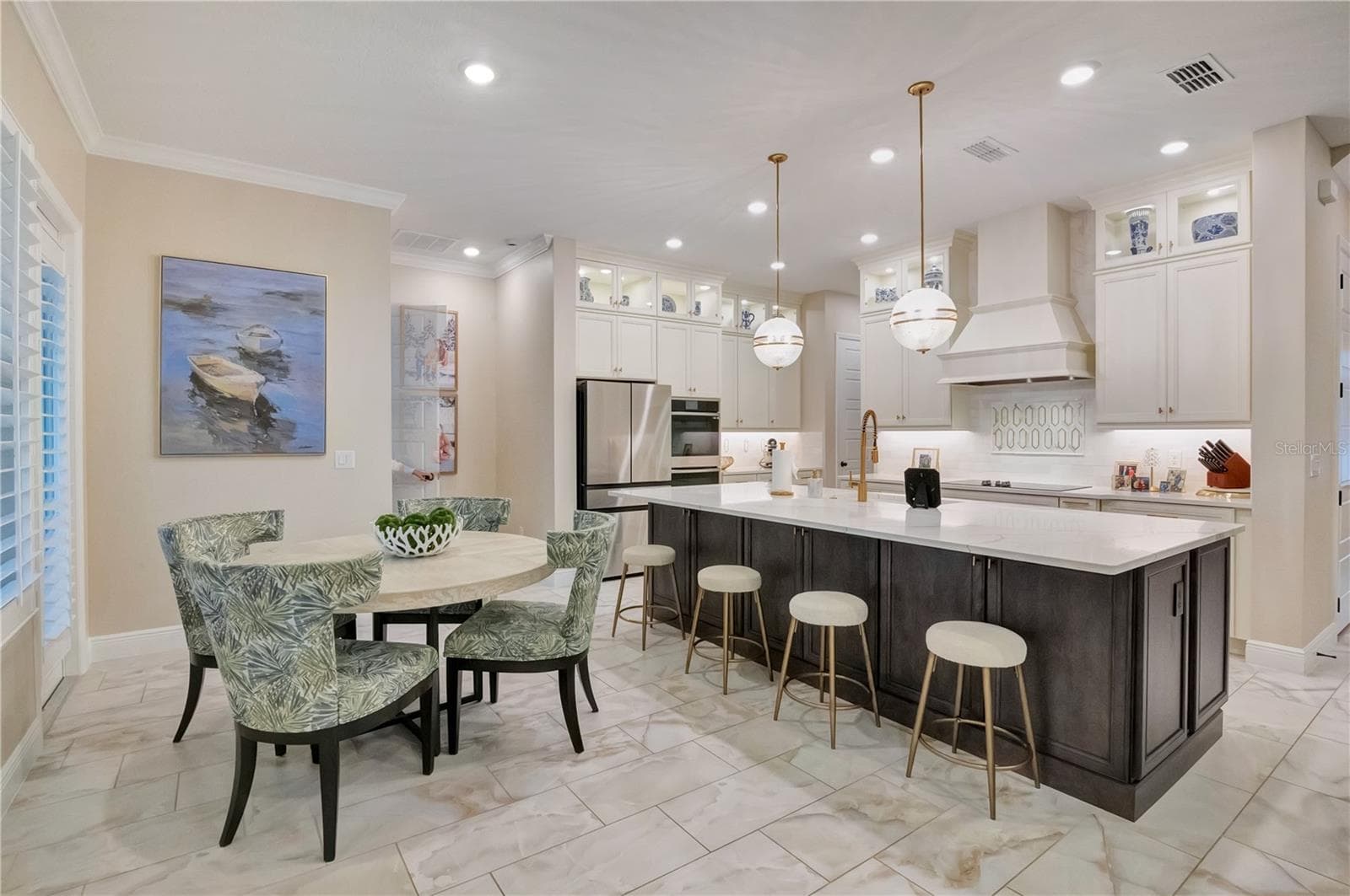 Spacious kitchen and breakfast area featuring upgraded tile flooring, crown molding and recessed lighting. - 17600 LAKE STAR RD, WINTER GARDEN