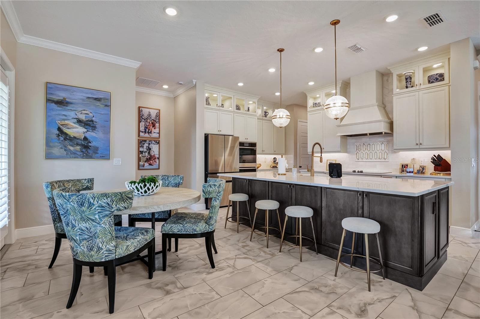 Breakfast nook and generous island seating provide multiple spaces for casual dining and gathering. - 17600 LAKE STAR RD, WINTER GARDEN