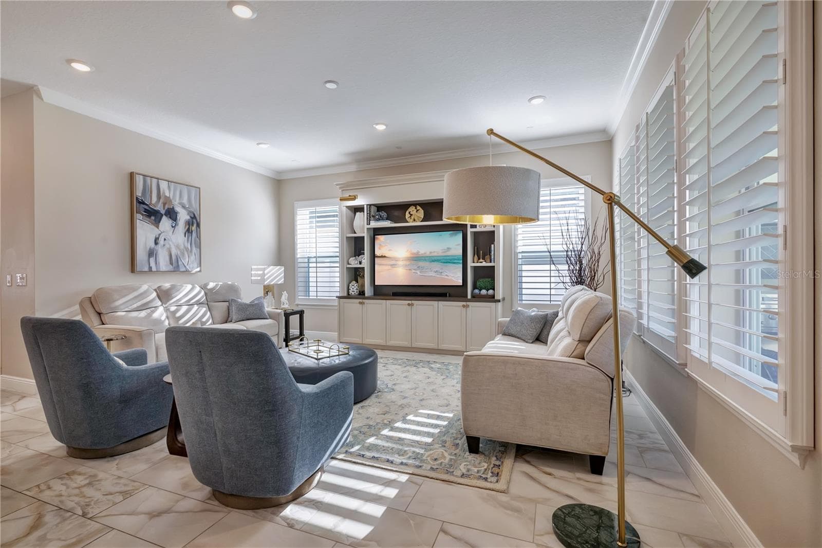 Inviting family room featuring crown molding, recessed lighting and plantation shutters. - 17600 LAKE STAR RD, WINTER GARDEN