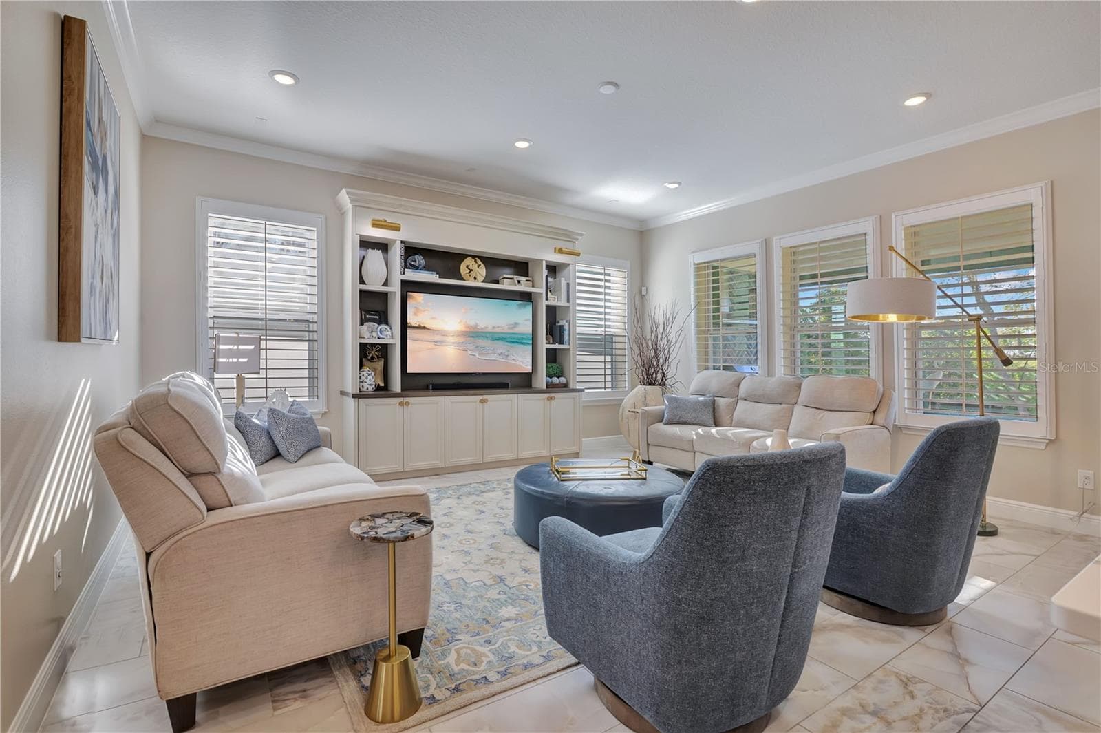 Bright family room with multiple windows and an open layout offers comfortable space for relaxing and entertaining. - 17600 LAKE STAR RD, WINTER GARDEN