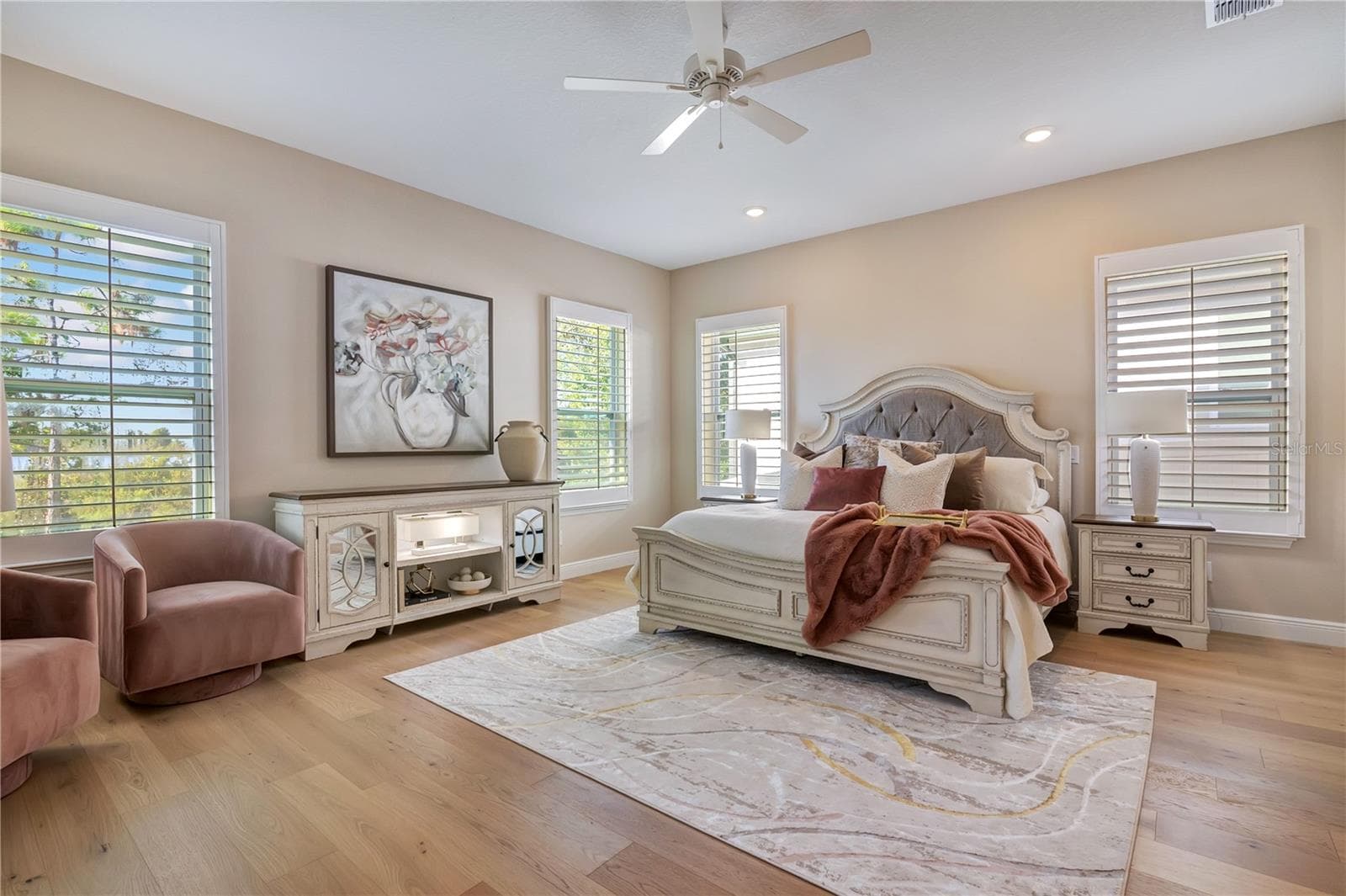 Spacious master featuring hardwood flooring, plantation shutters and abundant natural light, with room for a sitting area. - 17600 LAKE STAR RD, WINTER GARDEN