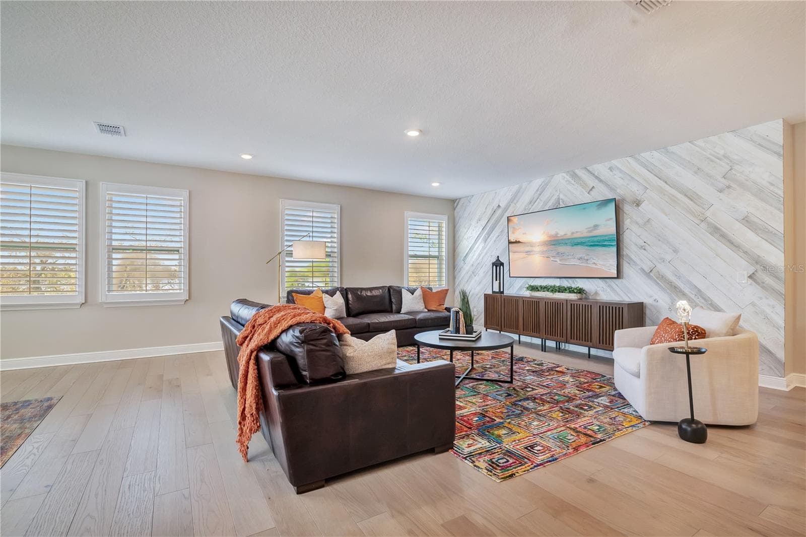 Spacious loft featuring a statement accent wall, recessed lighting and plantation shutters. - 17600 LAKE STAR RD, WINTER GARDEN