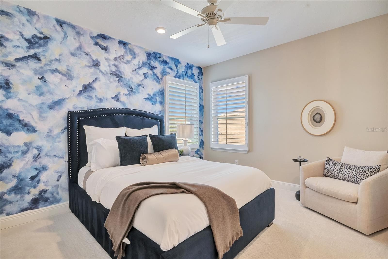 Bedroom featuring a blue statement accent wall, plush carpet and space for a reading chair. - 17600 LAKE STAR RD, WINTER GARDEN