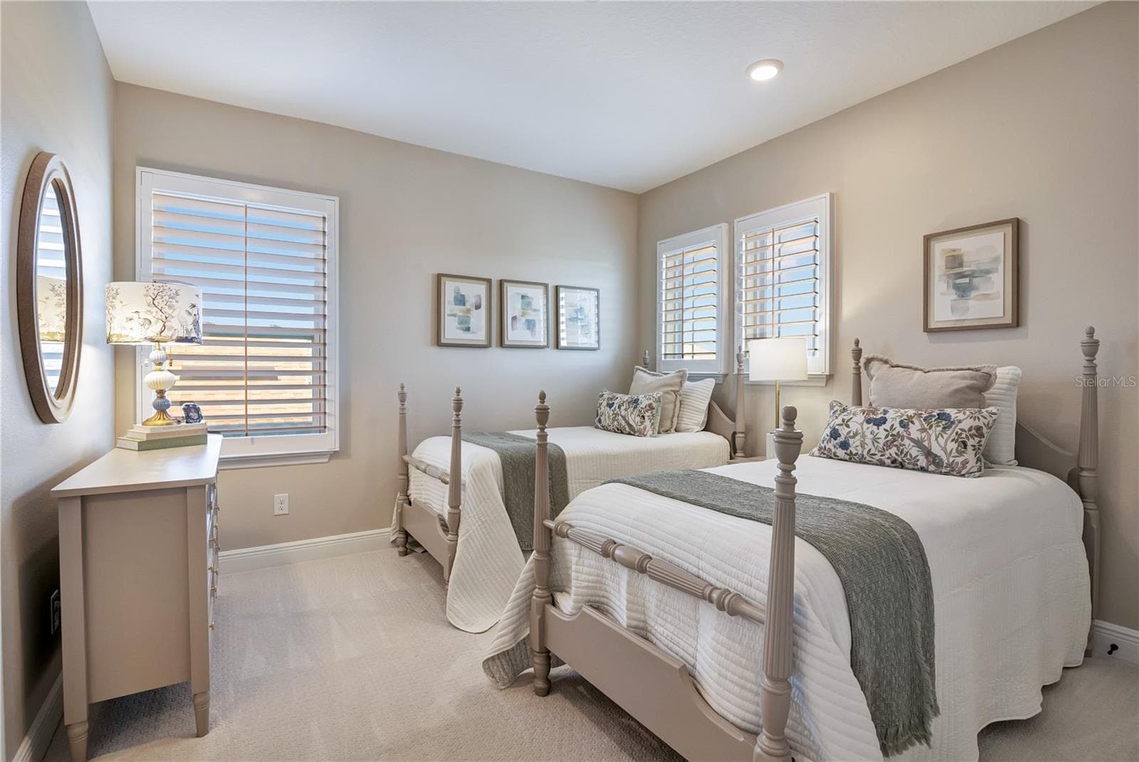 Comfortable bedroom featuring plush carpet, recessed lighting and plantation shutters. - 17600 LAKE STAR RD, WINTER GARDEN