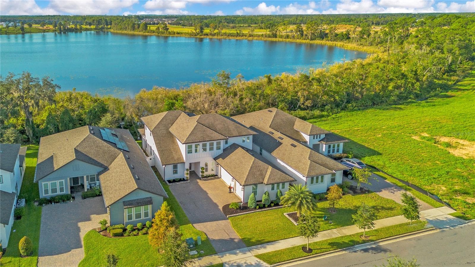 Lake views framed by mature trees and natural landscaping along the backyard. - 17600 LAKE STAR RD, WINTER GARDEN