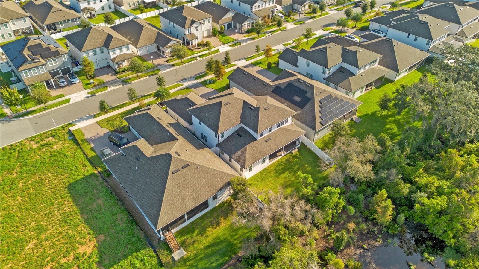 Wide aerial perspective shows the property’s location within the surrounding neighborhood. - 17600 LAKE STAR RD, WINTER GARDEN