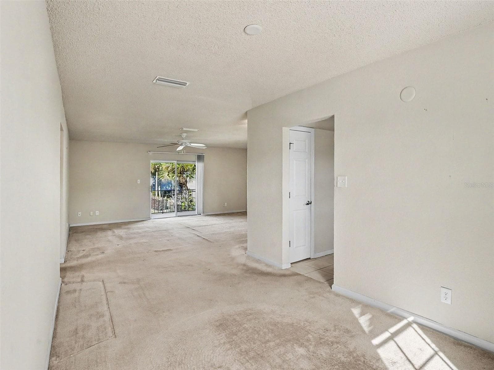 View from Dining to Living, Sliders to Balcony - 216 LEWFIELD CIR #216, WINTER PARK