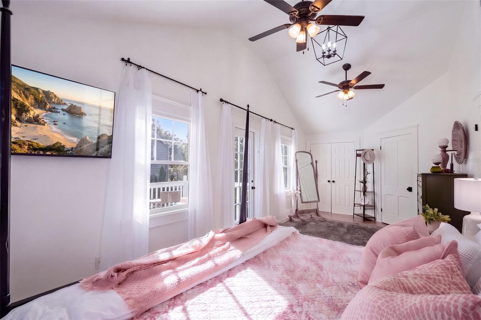 Beautiful UPSTAIRS PRIMARY BEDROOM featuring soaring vaulted ceilings, abundant natural light, and TWO CLOSETS, including a spacious WALK-IN CLOSET and a BUILT-IN CLOSET for additional storage. Charming FRENCH DOORS open to a cozy PRIVATE BALCONY, creating the perfect retreat to enjoy your morning coffee or unwind at the end of the day! - 1901 10TH ST, ST CLOUD