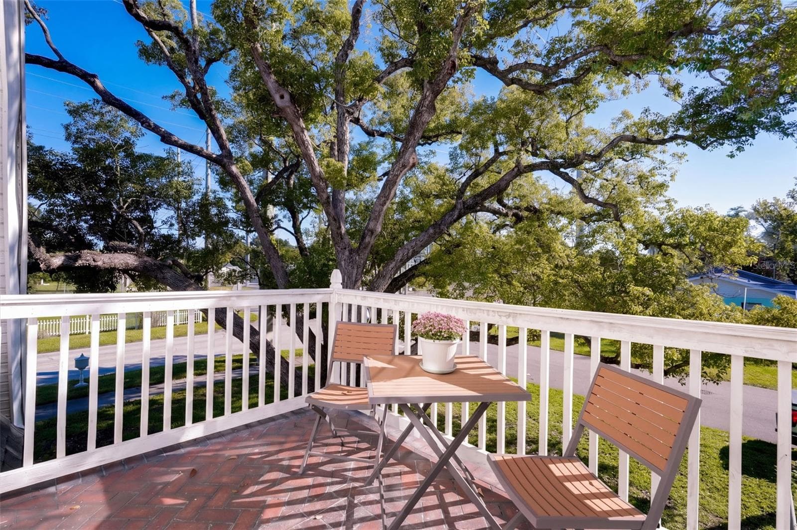 Step outside the UPSTAIRS PRIMARY BEDROOM onto your own charming PRIVATE BALCONY, the perfect retreat for enjoying morning coffee or relaxing with an evening beverage while taking in the beautiful views of mature oak trees and the peaceful surroundings! - 1901 10TH ST, ST CLOUD