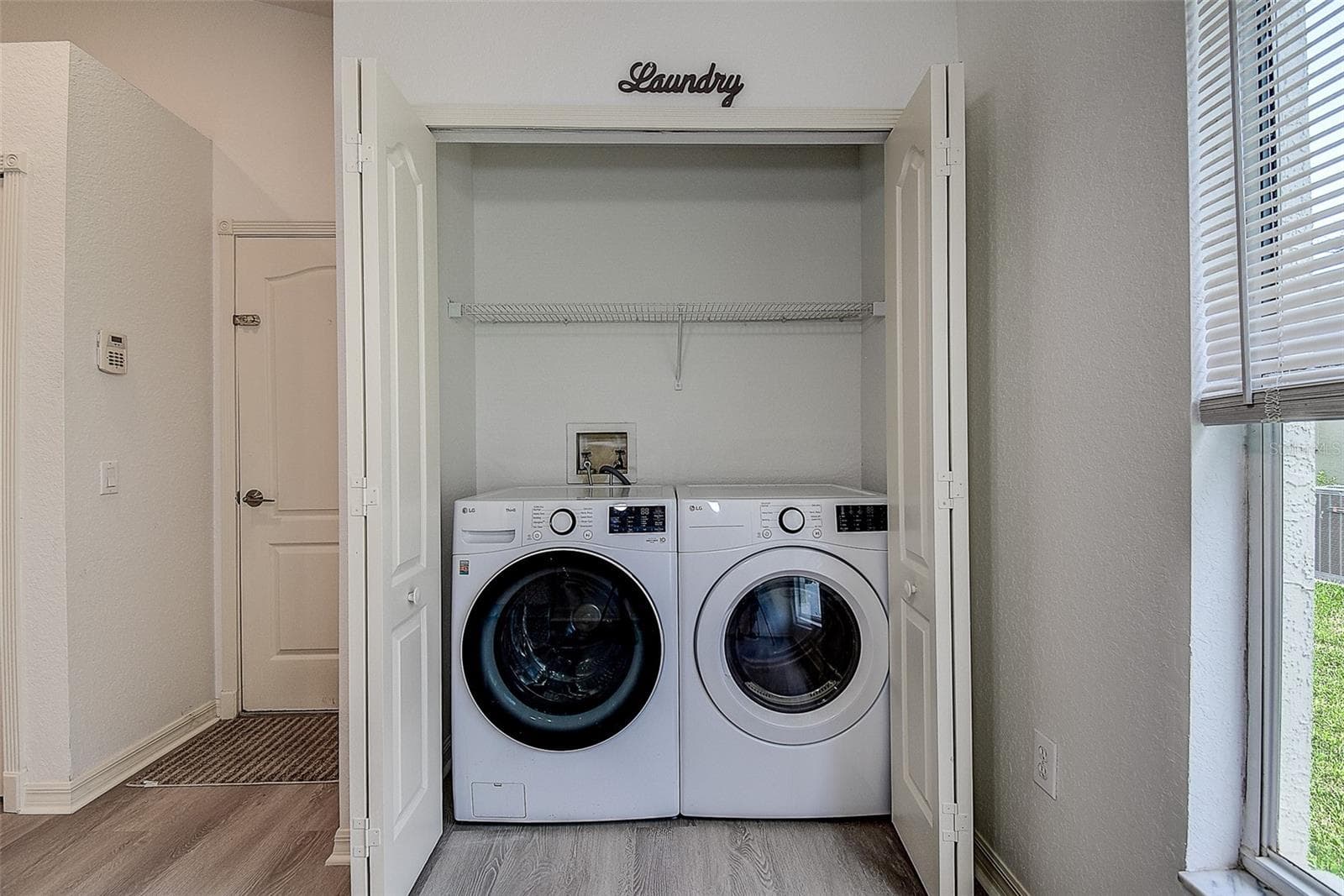 Laundry area in the kitchen - 28935 STORMCLOUD PASS, WESLEY CHAPEL