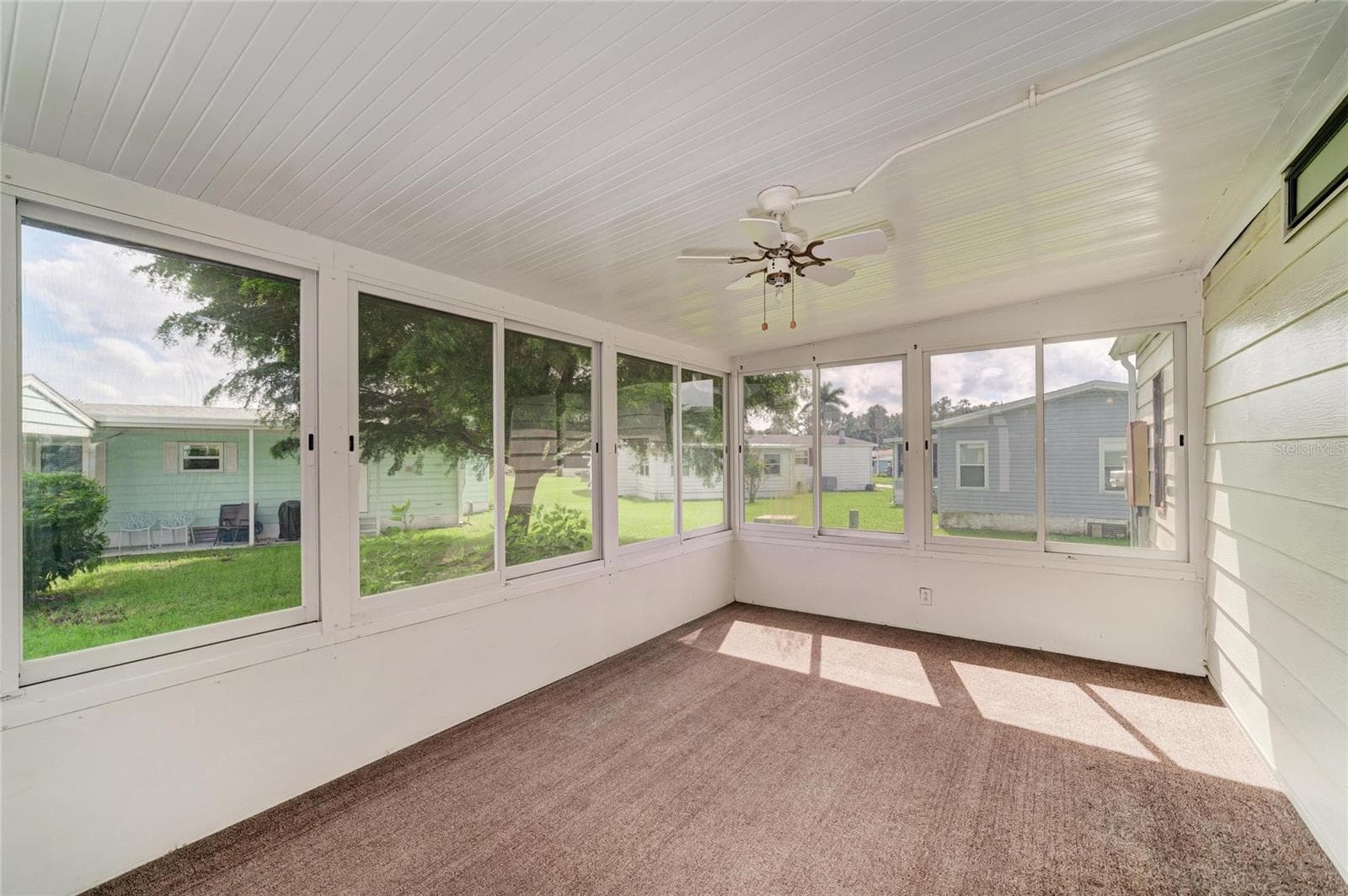 Nice and spacious sun room. Just add some pull down shades for added privacy. These are hard plastic windows, Good opportunity to add a mini-split for year round enjoyment. Sunroom accessible from laundry roof with additional door to carport. - 42 MEADOWLARK CIR, ELLENTON