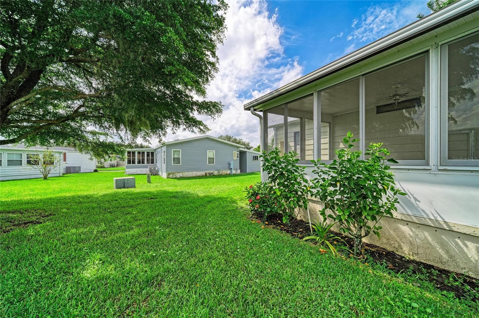 Nice shade tree from sunroom. with this lot you are not right on top of your neighbors. add rolldown shades for privacy. With the directional exposure you get morning sun and are spared the blazing afternoon sun - 42 MEADOWLARK CIR, ELLENTON
