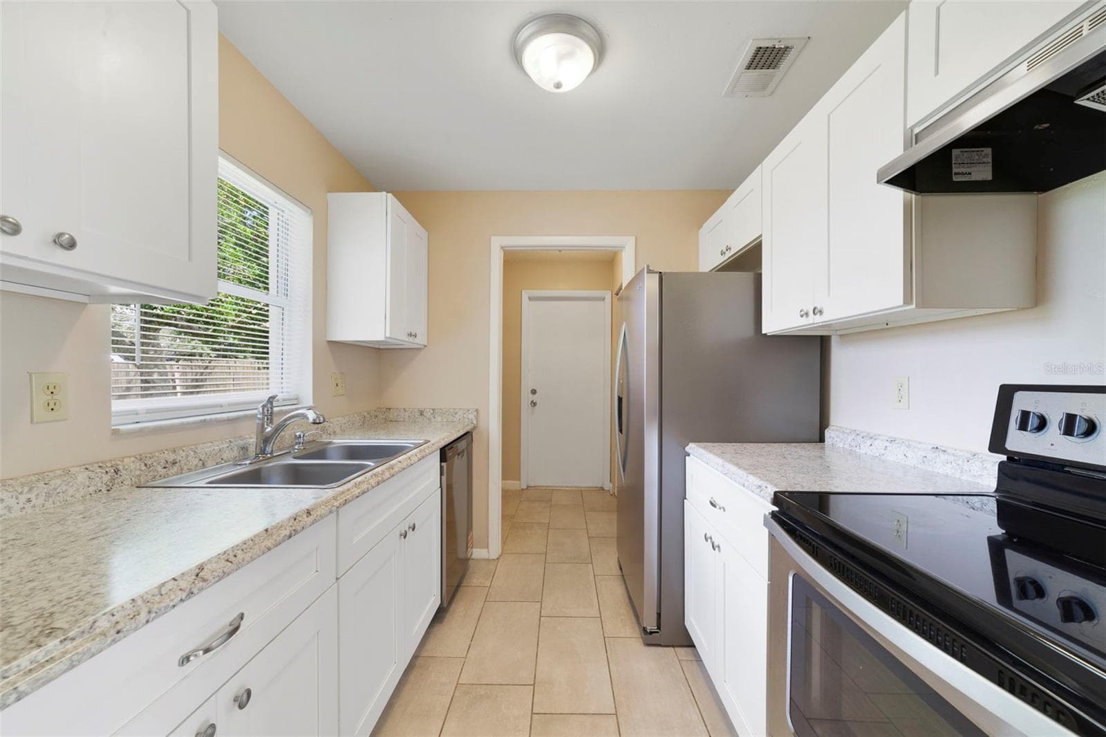 Kitchen features stainless steel appliances - 2638 BEAL ST, DELTONA