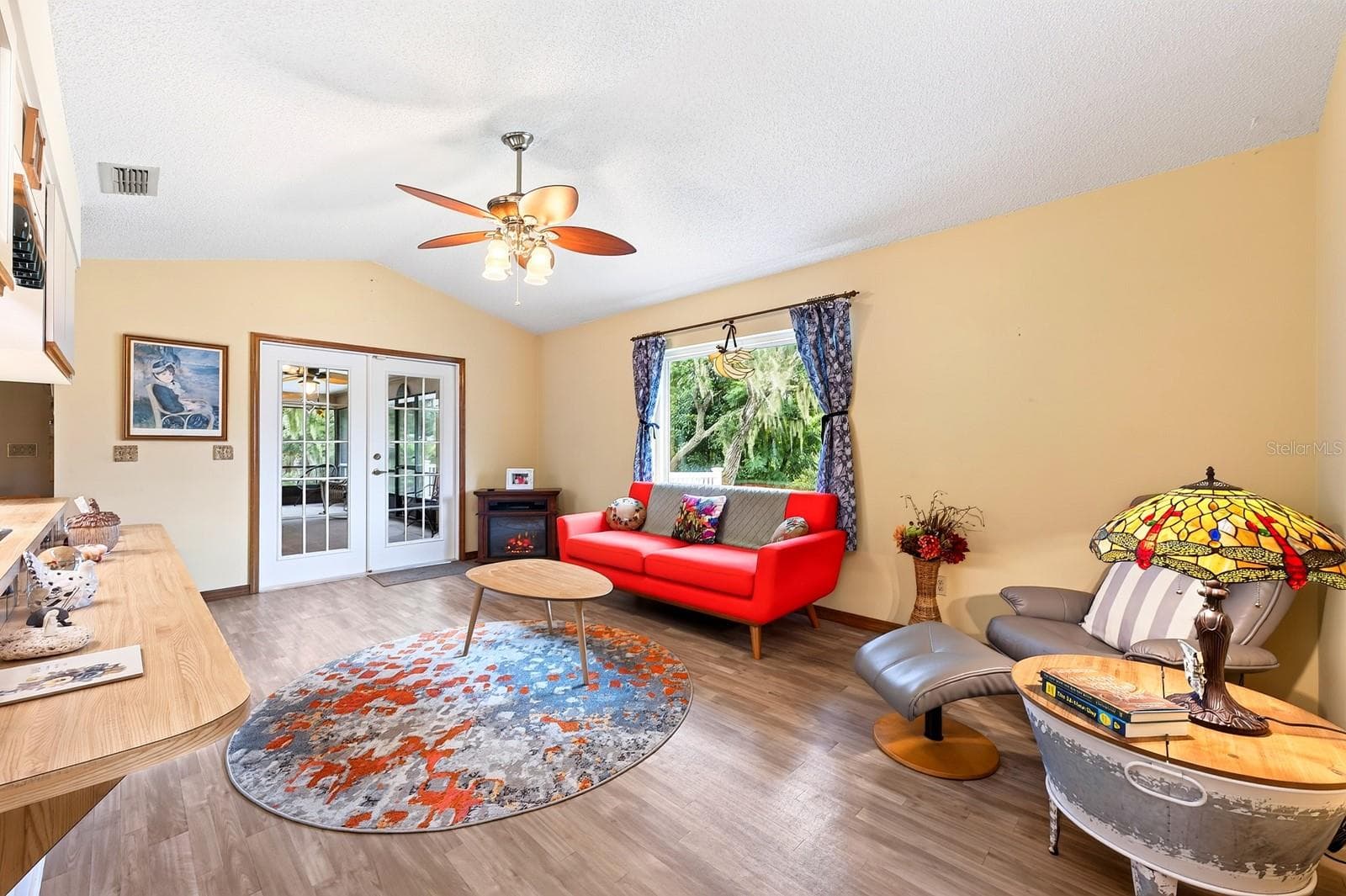 A set of GLASS-PANELED FRENCH DOORS in the Family Room open directly to the Florida Room, making it easy to move between the indoor living spaces and your own backyard retreat. - 2163 NEWMARK DR, DELTONA