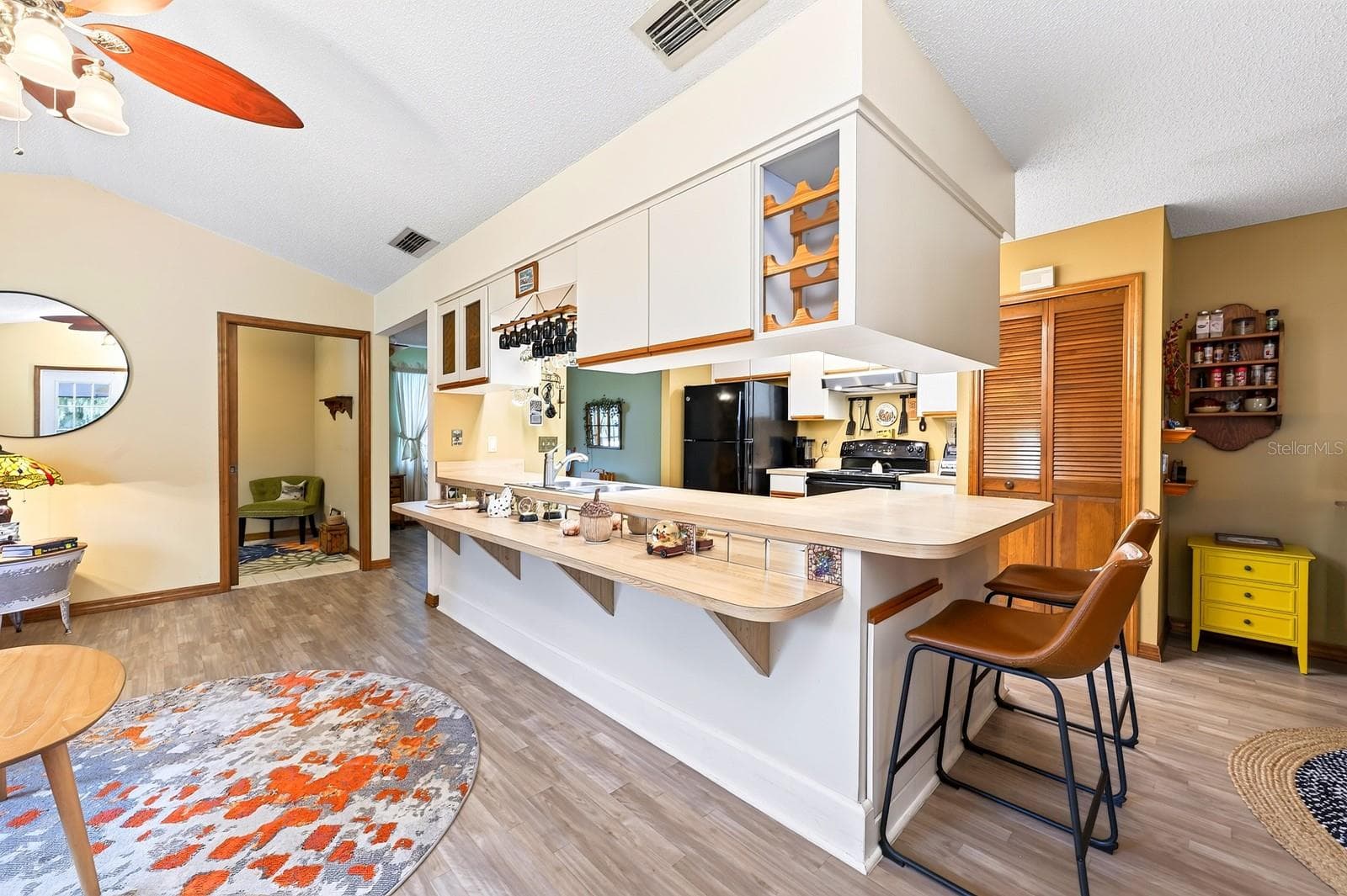 A GENEROUS KITCHEN BREAKFAST BAR makes meal preparation and casual gathering easy. - 2163 NEWMARK DR, DELTONA