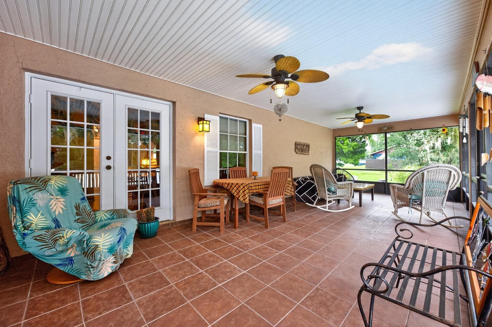 The FLORIDA ROOM is a standout feature, offering tile flooring, two modern ceiling fans, NEW SCREENS and a NEW CEILING. - 2163 NEWMARK DR, DELTONA
