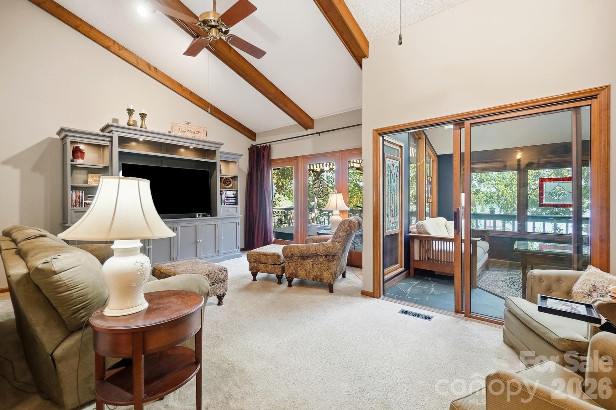 Lake facing great room with vaulted ceilings, stone fireplace, and lots of natural light - 1669 Aragon Beach Road, Rock Hill