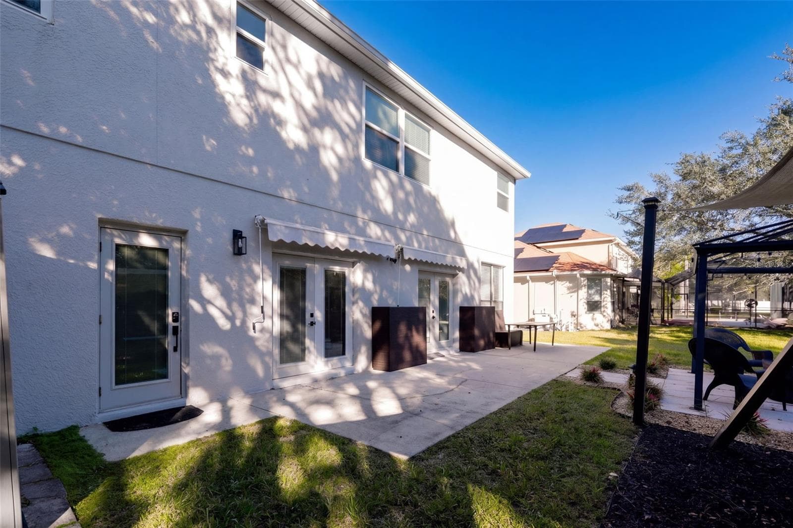 Rear back patio with double awnings - 10603 SUNRISE TERRACE DR, ORLANDO