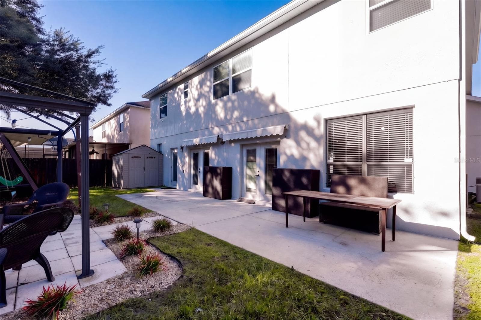 Back yard patio with double awning - 10603 SUNRISE TERRACE DR, ORLANDO