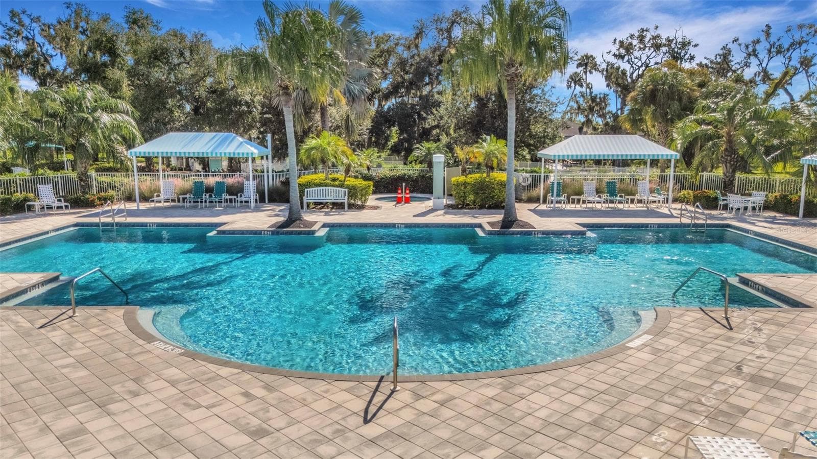 Enjoy the Silverleaf community pool, complete with a shaded poolside seating area for relaxing and gathering with neighbors. - 10426 CROOKED CREEK CT, PARRISH
