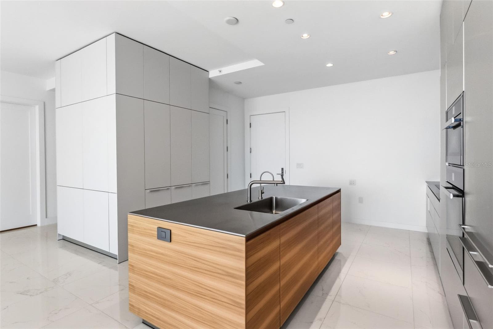 Island with Bulthaup faucet and stainless steel counters - 111 S PINEAPPLE AVE #1103, SARASOTA