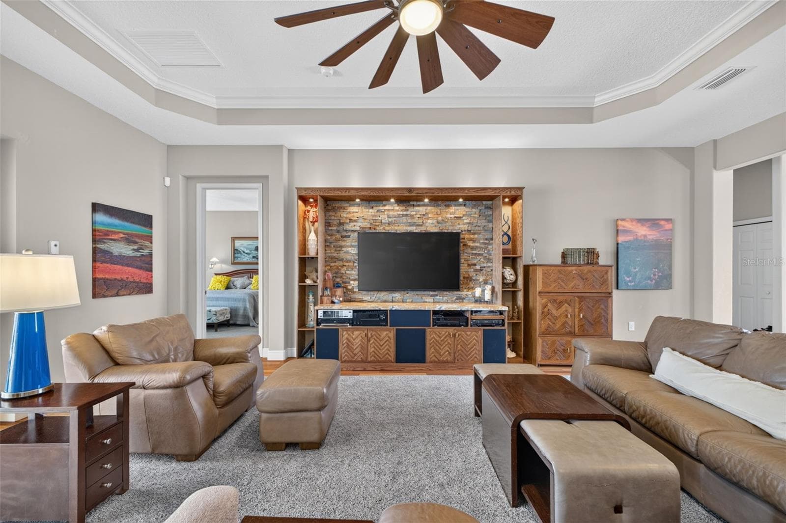 Sophisticated 11-foot coffered ceilings and an expansive open floor plan anchor this light-filled great room. - 2444 PAWTUCKET PASS, MOUNT DORA