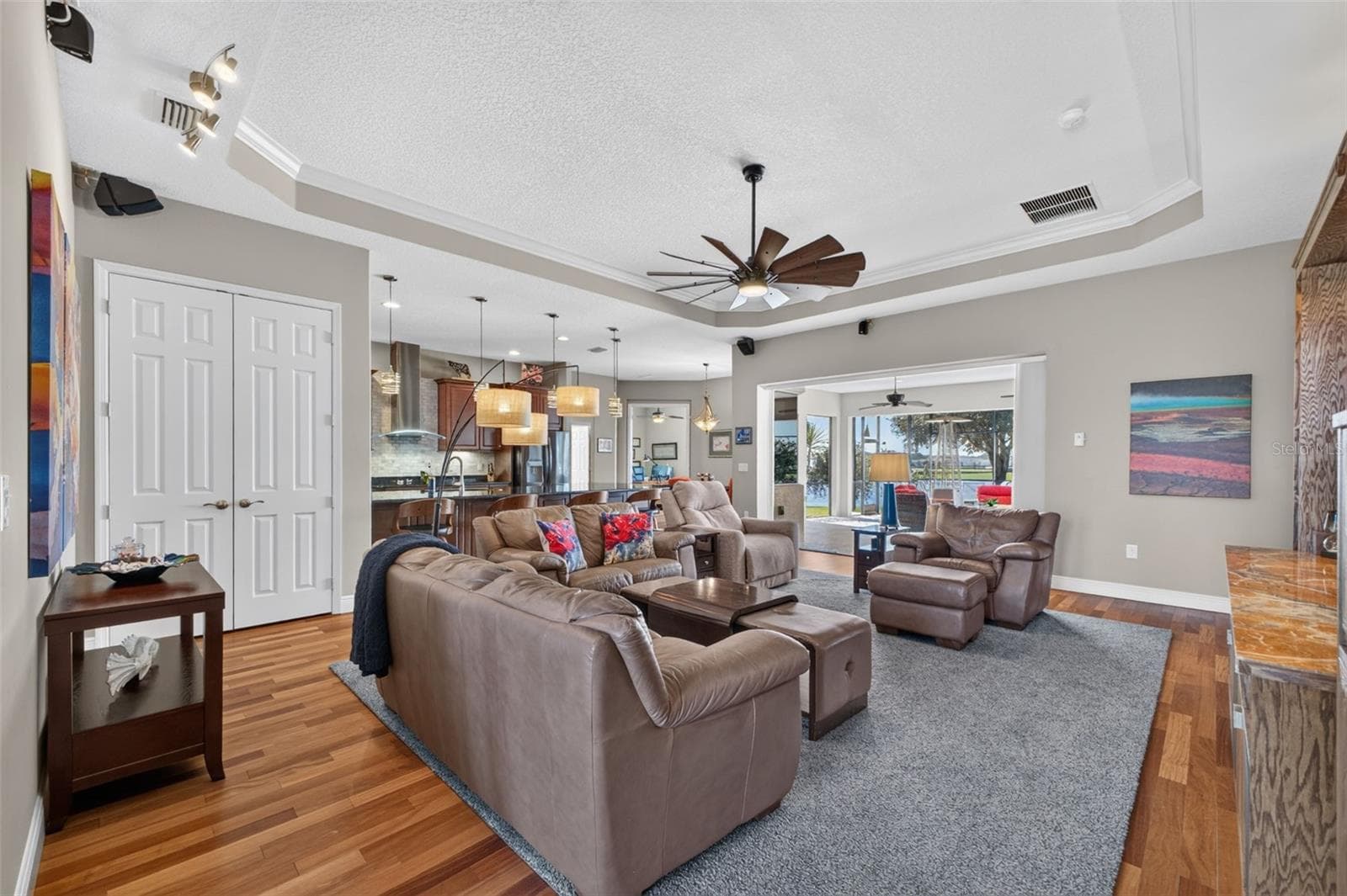 An expansive great room flows effortlessly into the casual dining area and kitchen, creating the ultimate hub for daily living and entertaining. - 2444 PAWTUCKET PASS, MOUNT DORA