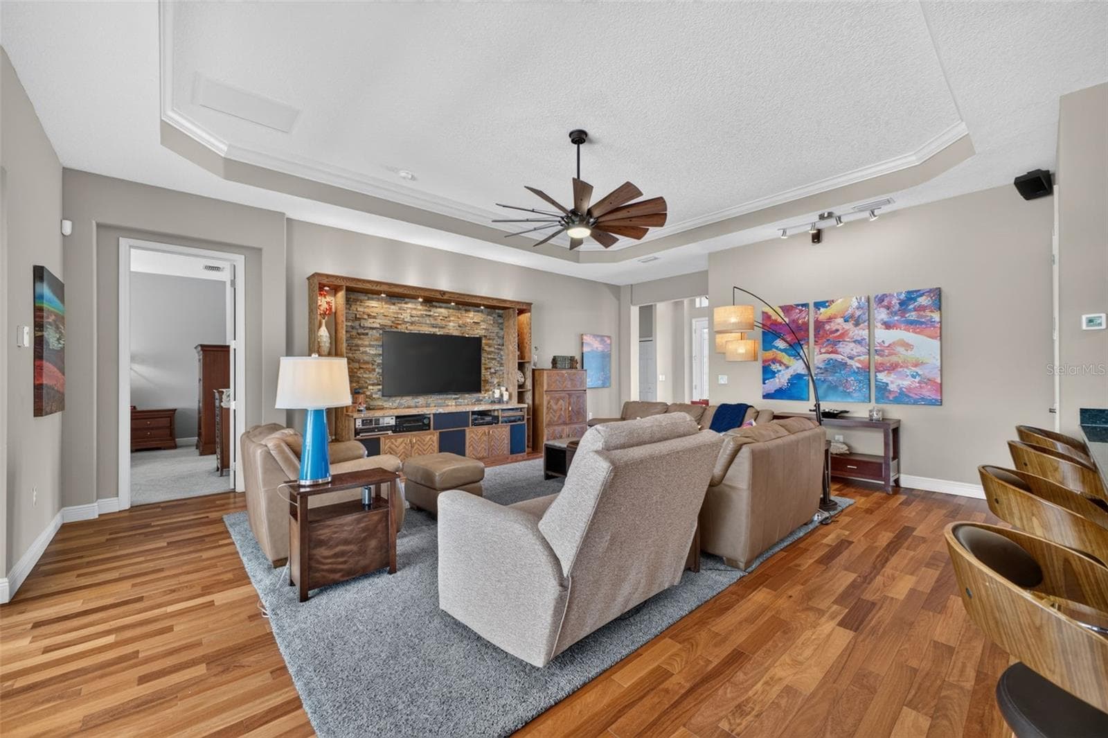 Stunning Brazilian Teak engineered hardwood flooring adds incredible depth and elegance to the spacious great room. - 2444 PAWTUCKET PASS, MOUNT DORA