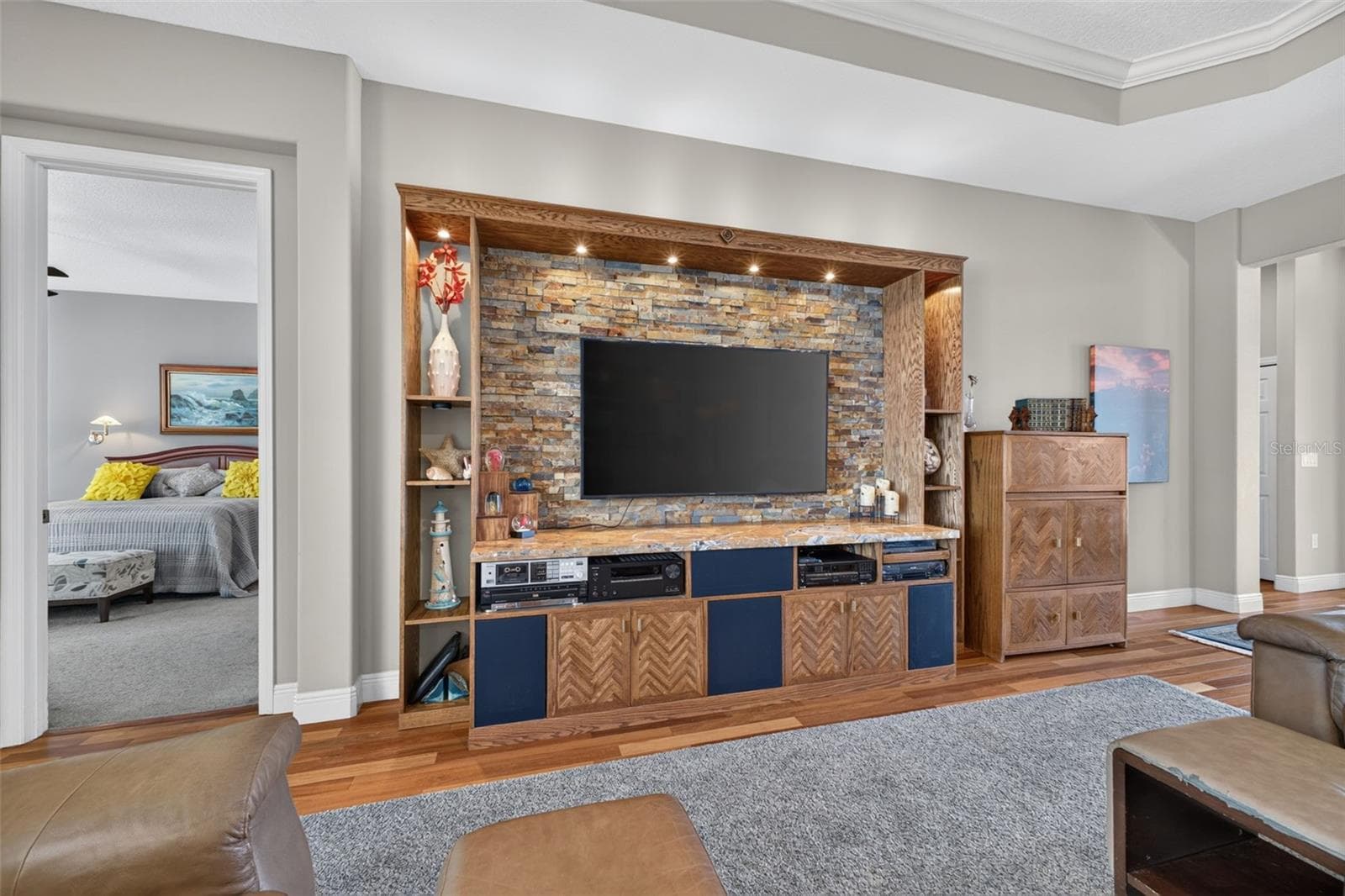 Positioned off the great room for optimal privacy, the main-level primary suite enjoys direct access to the lanai and pool. - 2444 PAWTUCKET PASS, MOUNT DORA