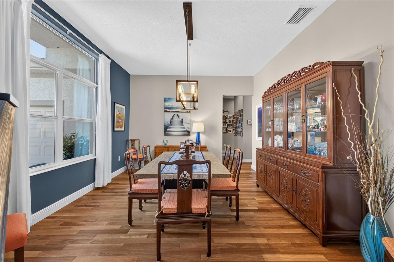 Positioned at the front of the home, this elegant formal dining area greets guests with style and charm. - 2444 PAWTUCKET PASS, MOUNT DORA
