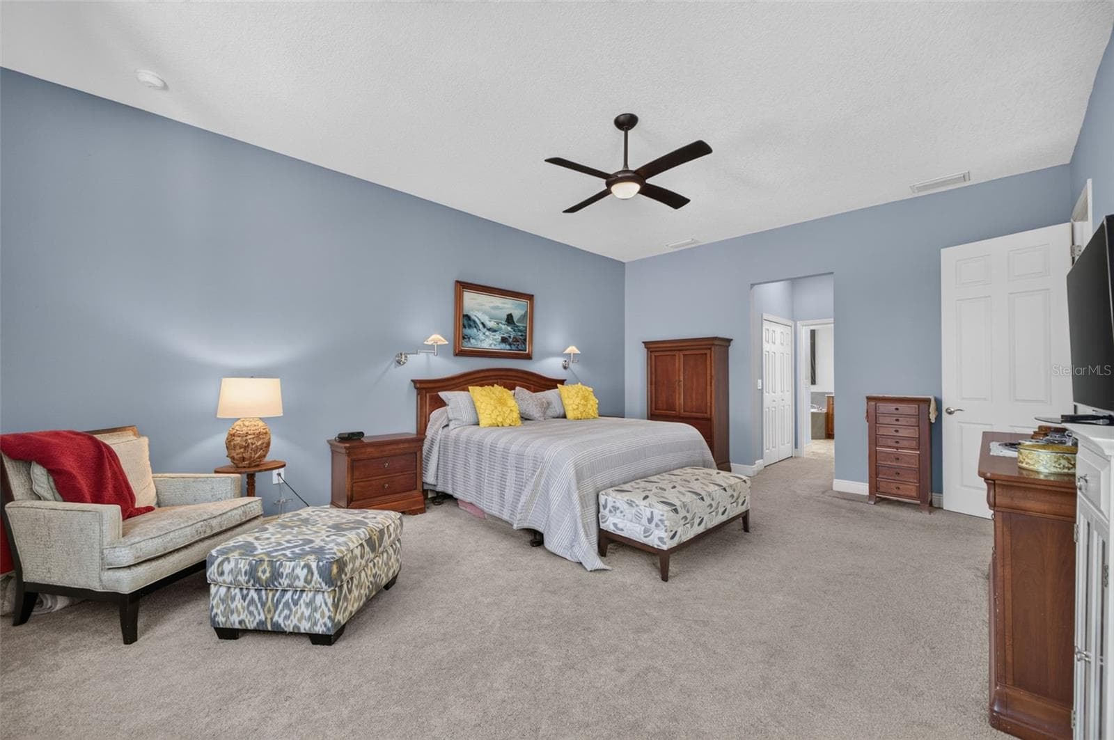 A serene sanctuary, this sunlit primary retreat offers expansive dual walk-in closets and an exquisite, spa-inspired en-suite bathroom. - 2444 PAWTUCKET PASS, MOUNT DORA