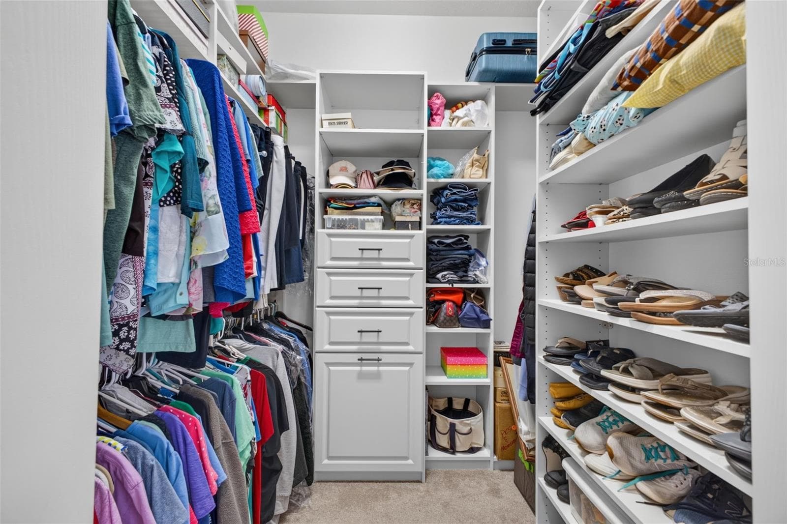 The primary suite features generous dual walk-in closets, providing ample room for extensive wardrobes and personal storage. - 2444 PAWTUCKET PASS, MOUNT DORA