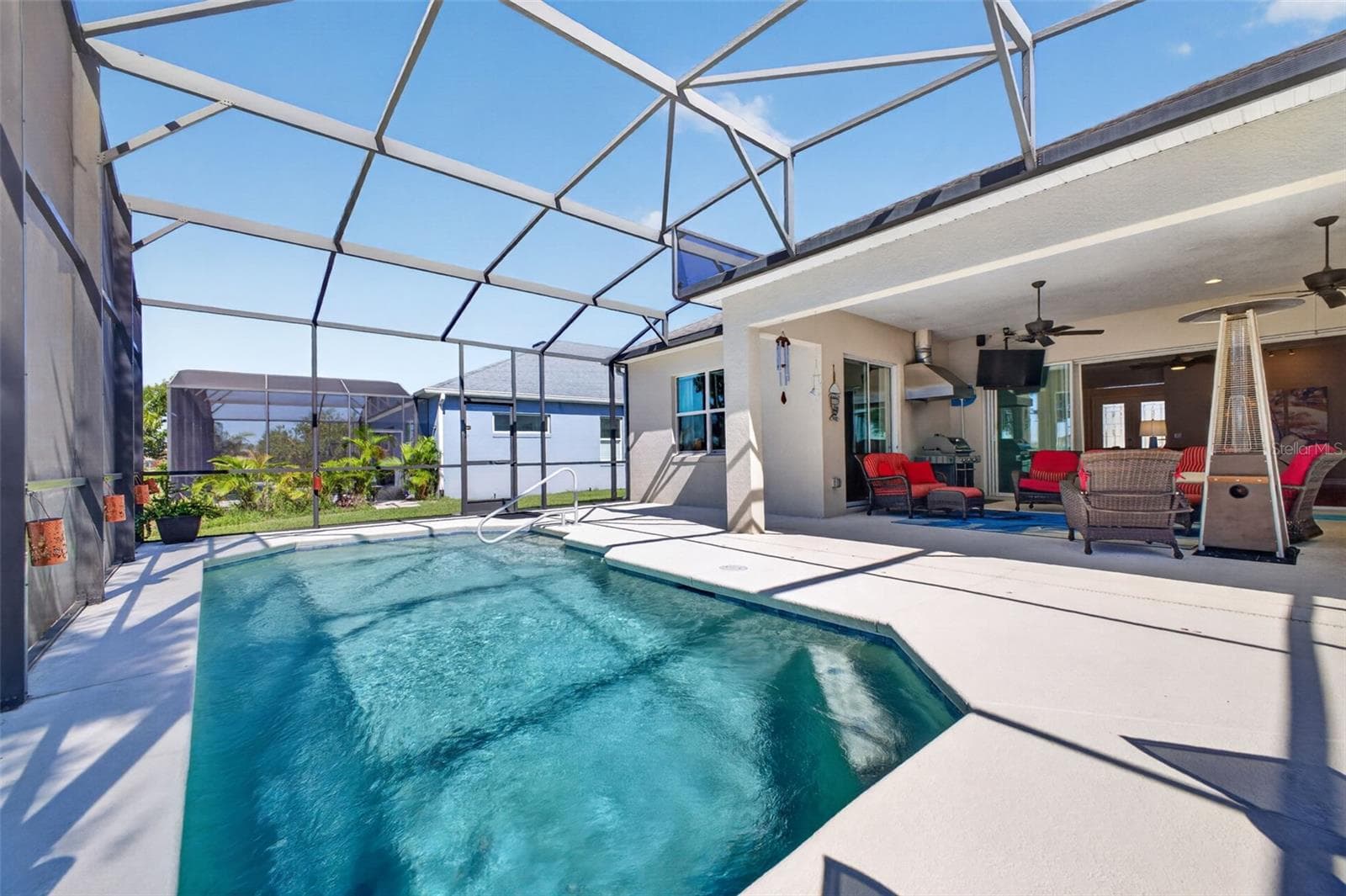 A screened pool cage offers easy, low-maintenance living for the generous 23' x 13' swimming pool. - 2444 PAWTUCKET PASS, MOUNT DORA