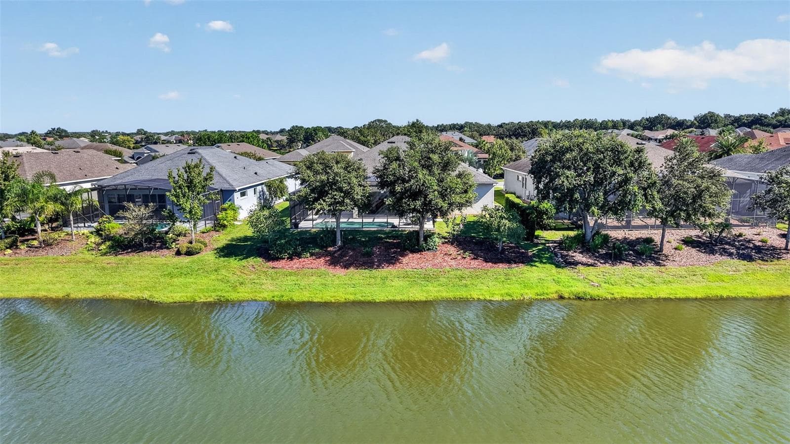 Mature oak trees line the rear of the property, providing natural shade and added privacy. - 2444 PAWTUCKET PASS, MOUNT DORA