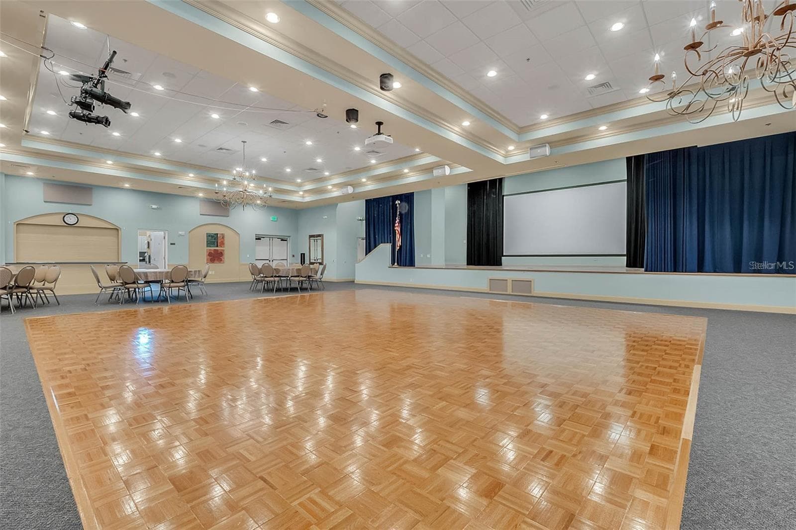 The community center features a built-in stage and spacious dance floor, ideal for hosting social events, performances, and neighborhood celebrations. - 2444 PAWTUCKET PASS, MOUNT DORA