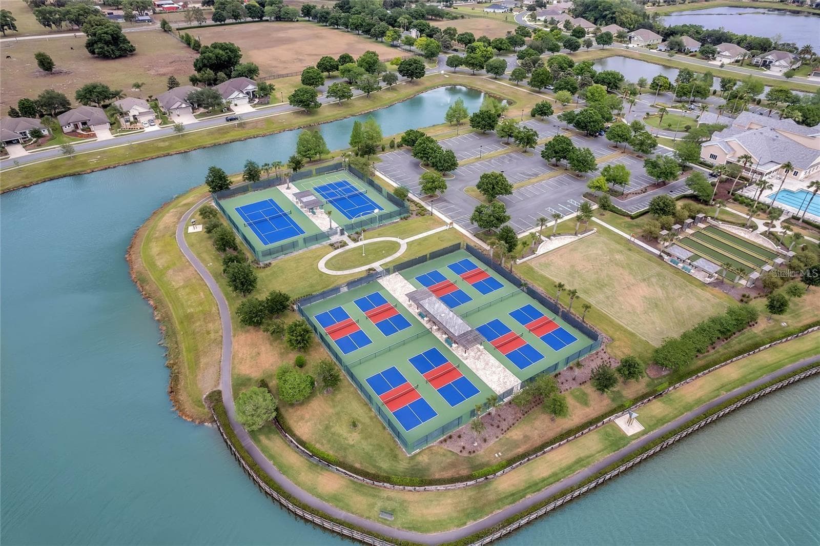The community features a championship-grade sports complex equipped with tennis, pickleball, and manicured croquet lawns for year-round play. - 2444 PAWTUCKET PASS, MOUNT DORA
