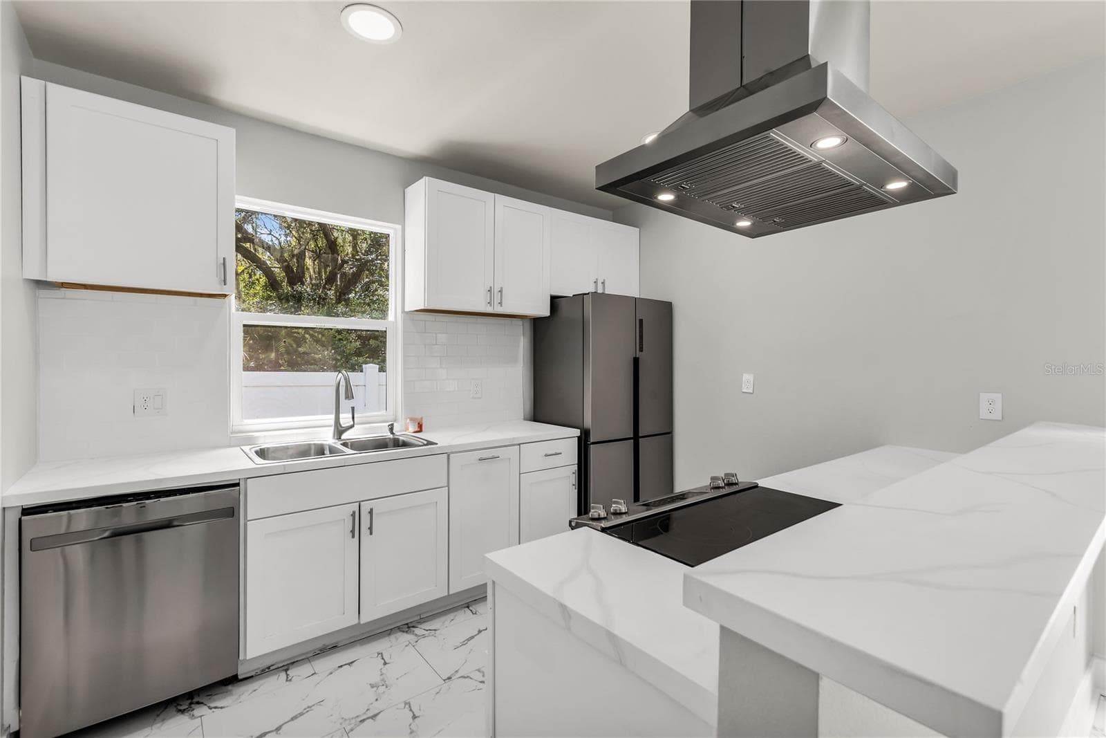 Kitchen features granite countertops, modern subway tile backsplash and stainless steel appliances. - 3954 S SANFORD AVE, SANFORD