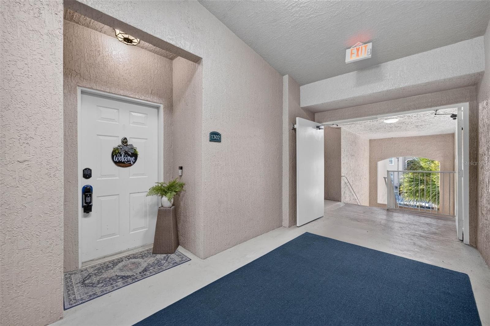 Front door and covered entry hallway - 4849 CYPRESS WOODS DR #1302, ORLANDO