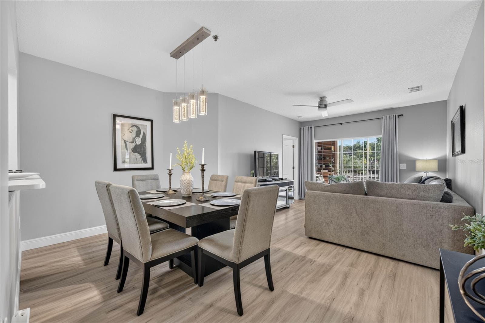 Open dining and living room with ceiling fan - 4849 CYPRESS WOODS DR #1302, ORLANDO