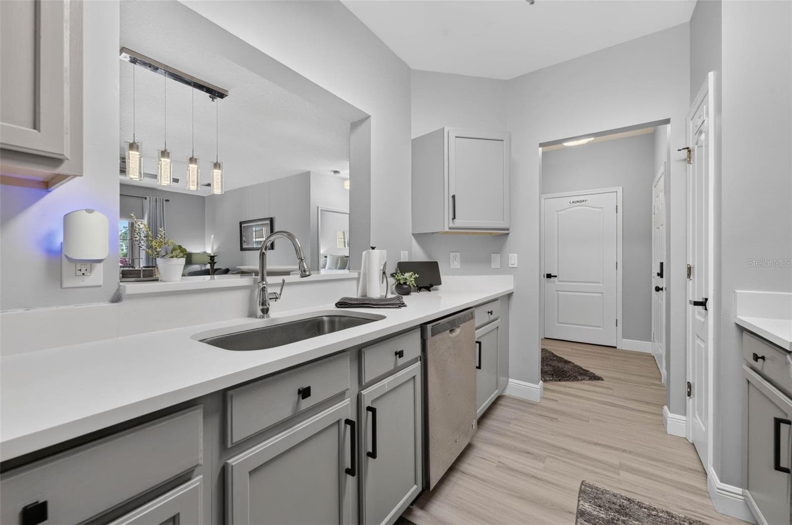 Kitchen sink and pendant lights over dining area - 4849 CYPRESS WOODS DR #1302, ORLANDO