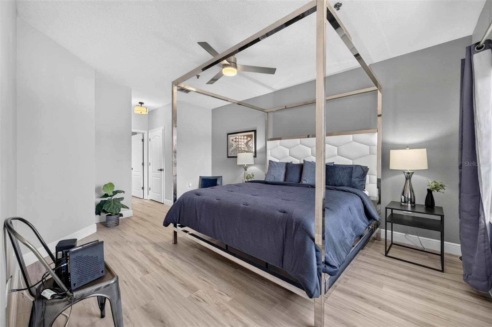 Primary bedroom with canopy bed - 4849 CYPRESS WOODS DR #1302, ORLANDO