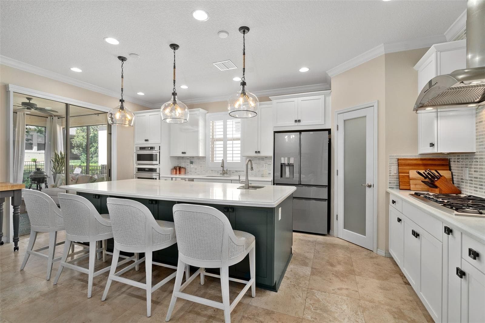 The Gourmet kitchen option includes built-in Monogram Appliances (Cooktop, Built-in Convection Oven, Microwave and Wine Fridge) a Cafe' Glass Front Refrigerator (newer). Island prep sink, Breakfast Bar and Front Facing Cabinetry for additional storage. - 1038 TIMBERVALE TRL, CLERMONT