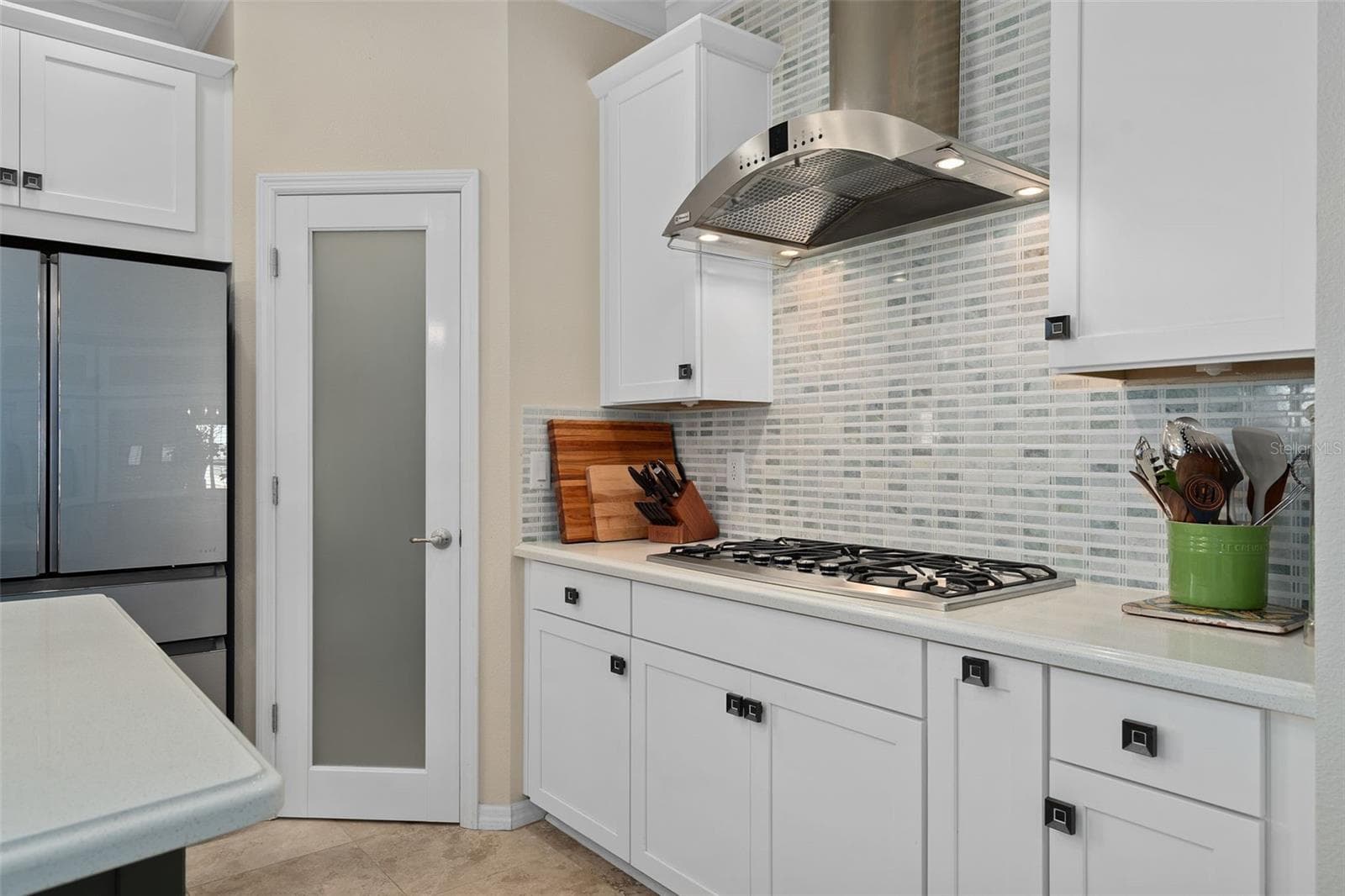 Corner Pantry with a Custom Frosted Glass Door. The Pantry has been outfitted with Custom Organization including a Lazy Susan. - 1038 TIMBERVALE TRL, CLERMONT