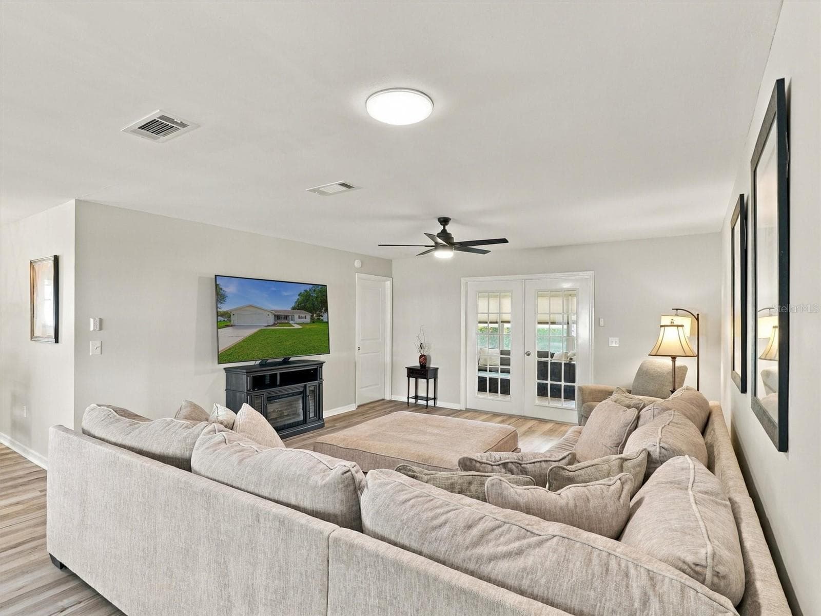 Living Room with Comfortable Sofa and 65" TV, Solar Tube - 9892 SE 177TH LN, SUMMERFIELD