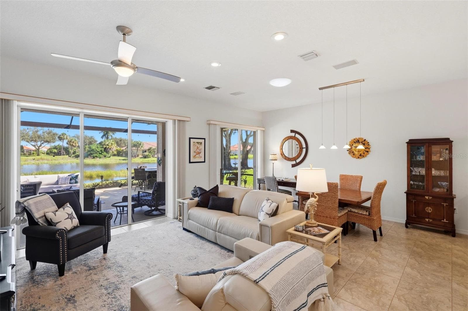 Living room/dining room with water views - 687 LAKESCENE DR, VENICE