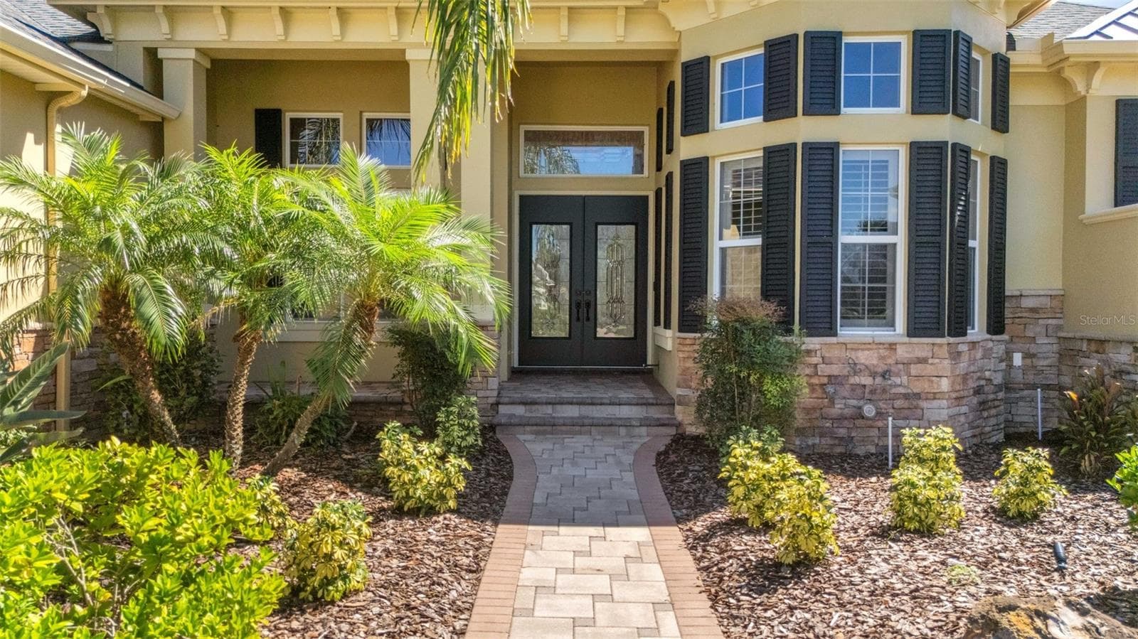 The wide deep elevated entry boasts stone accents, brick pavers and dual leaded glass entry doors. - 6562 EAGLE VIEW LOOP, LAKELAND